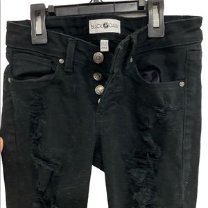 Black Daisy ripped black skinny button fly jeans